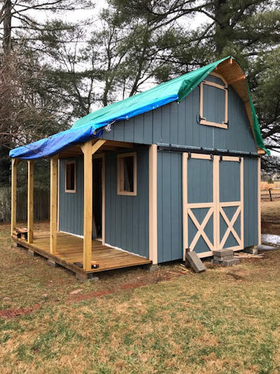 Looks like the roof is all that's left to do on Rogers 12x16 barn with porch shed. More shed pictures of Rogers 12x16 barn shed with side porch.